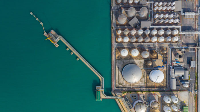 overhead view of oil tanks along the water