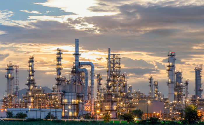 large oil refinery at sunset